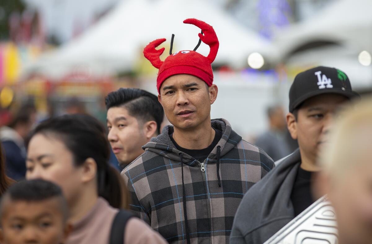 Noel Laeno wears a crawfish hat during the Crawfish Festival at Mile Square Park on Friday.