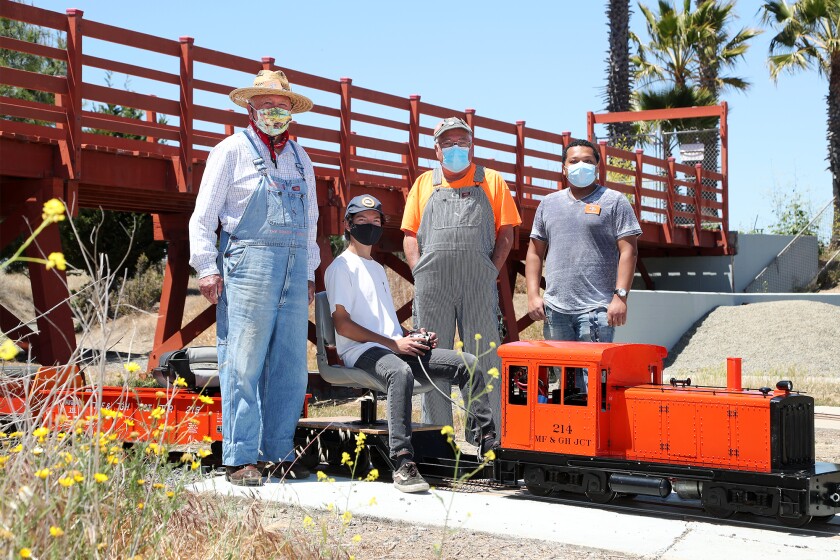 Volunteers with Orange County Model Engineers pose in front of the Hank Hornsveld Memorial Trestle in Fairview Park.