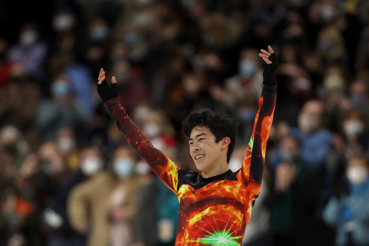 Nathan Chen raises his hands while competing in the U.S. Figure Skating Championships