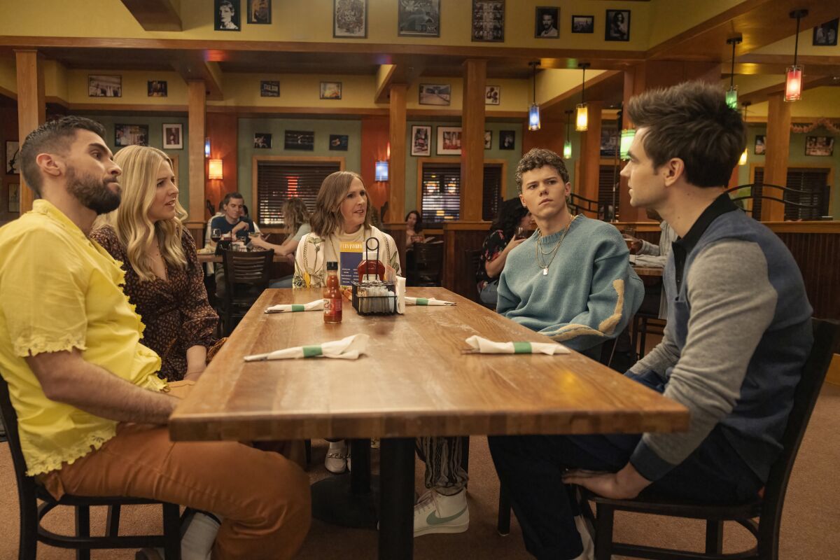 Josh Segarra, Heléne Yorke, Molly Shannon, Case Walker and Drew Tarver sit around a dining table.