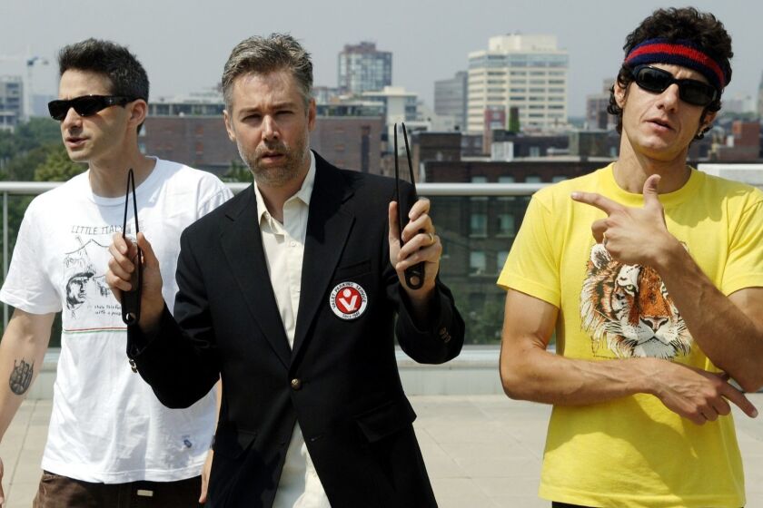 Beastie Boys Adam Yauch 'MCA,' center, Adam Horovitz 'Adrock,' left, and Mike Diamond 'Mike D' pose for a photograph in Toronto, Wednesday, July 26, 2006. (AP PHOTO/CP, Aaron Harris) ORG XMIT: CPT107