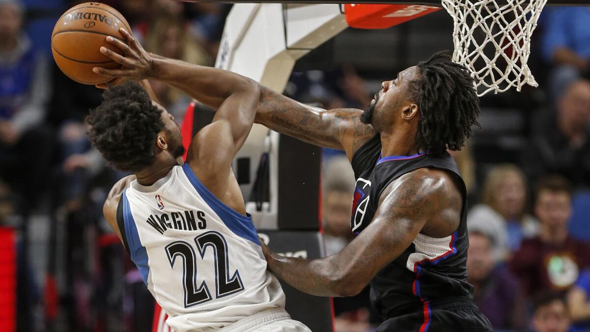 Clippers center DeAndre Jordan tries to block a shot by Timberwolves forward Andrew Wiggins (22) during the second half Saturday.