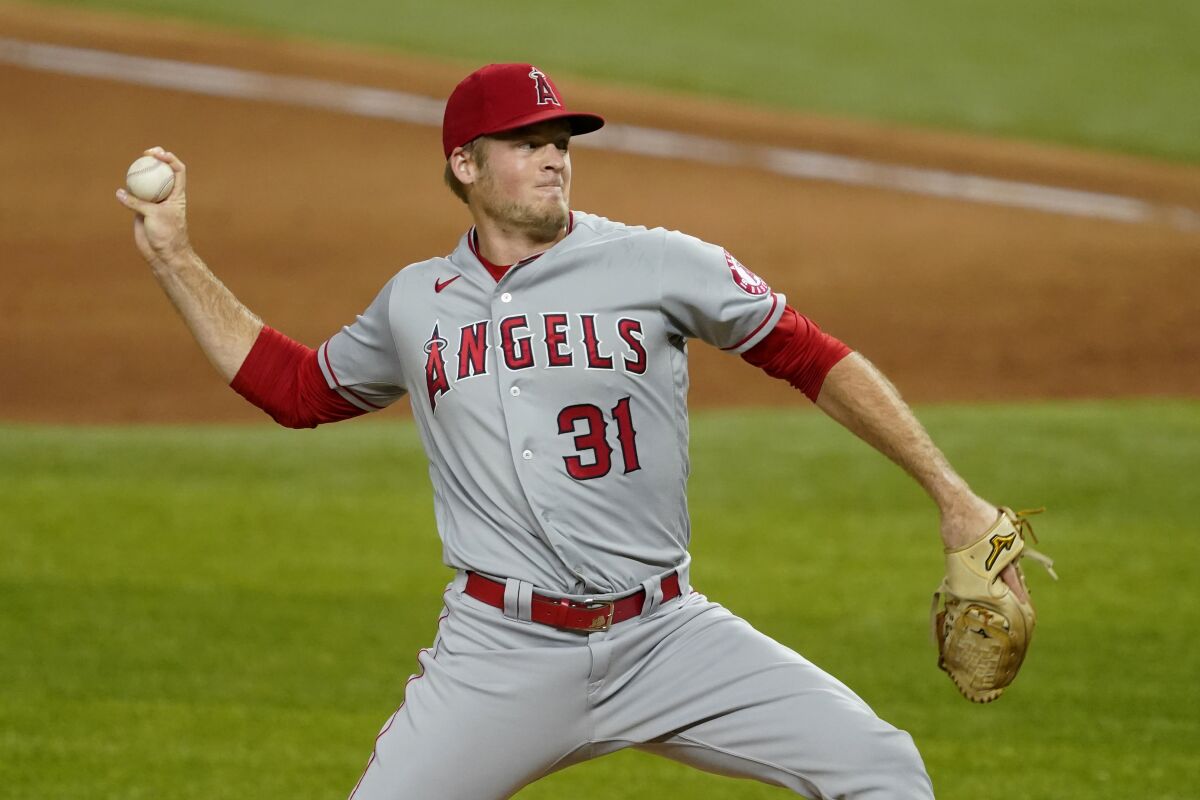 Angels relief pitcher Ty Buttrey throws to a Texas Rangers batter.