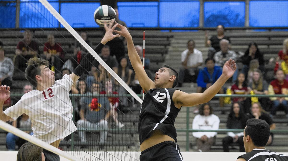 COSTA MESA, CA, May 10, 2016 -- Costa Mesa High's Mason Tufuga, right, scores against El Modena's Andrew Reina during the third set in a first-round CIF Southern Section Division 2 playoff game in Costa Mesa on Tuesday. (Kevin Chang/ Daily Pilot)