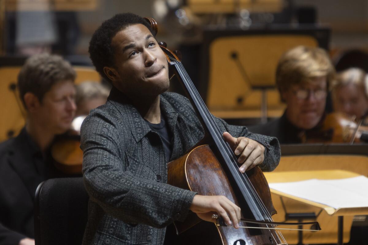 A seated person plays the cello.