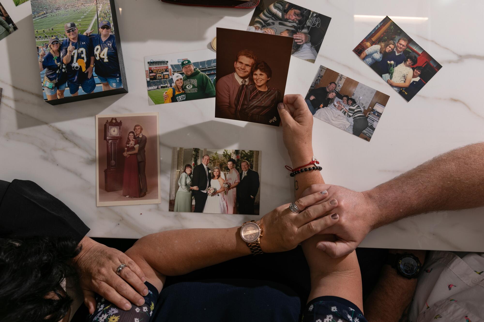 Mychelle Blandin looks at photos of her mom, dad and sister