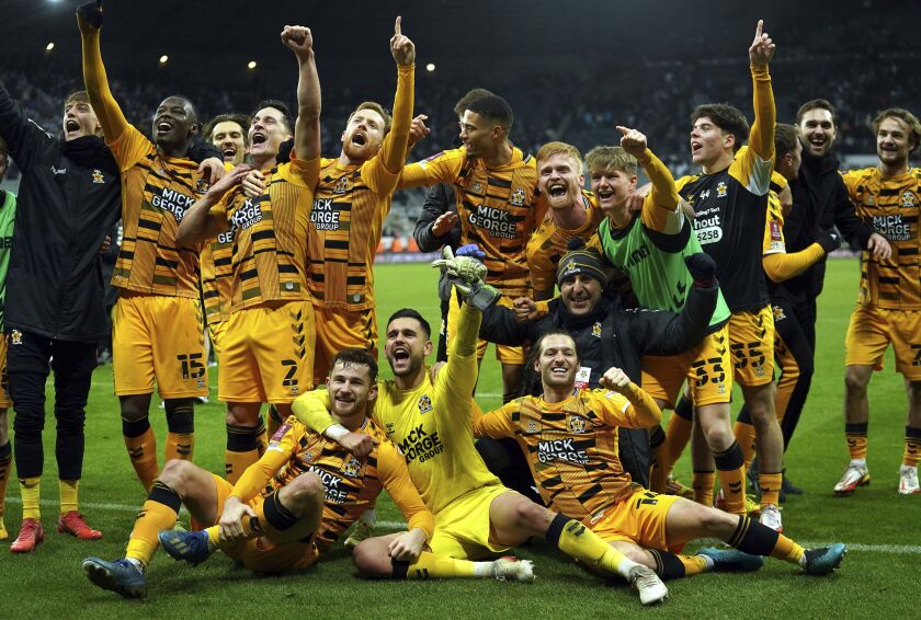 Cambridge United players celebrate victory after the final whistle of the English FA Cup third round soccer match between Newcastle United and Cambridge United at St. James' Park, Newcastle upon Tyne, England, Saturday Jan. 8, 2022. (Owen Humphreys/PA via AP)