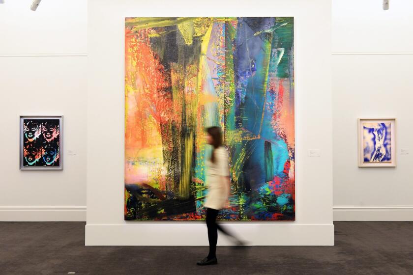 A Sotheby's staff member walks past Gerhard Richter's "Abstraktes Bild," which sold for more than $46 million this week after going for just $607,500 in a 1999 auction.