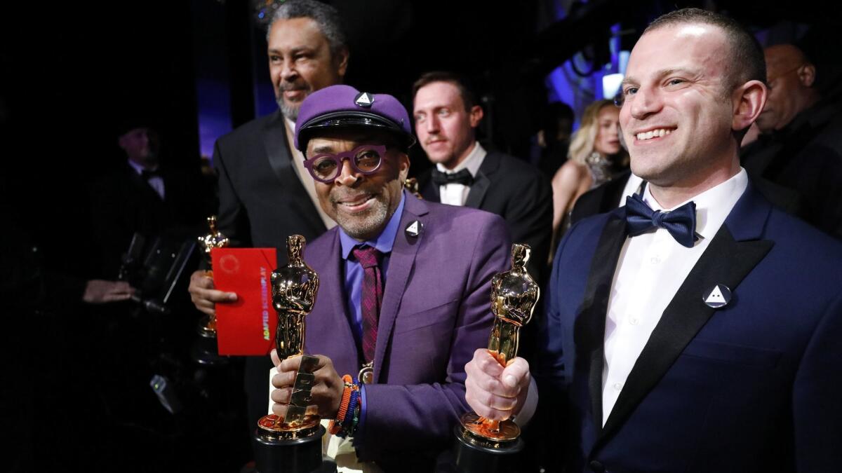Spike Lee after winning the adapted screenplay Oscar. Co-writer Charlie Wachtel is at right.