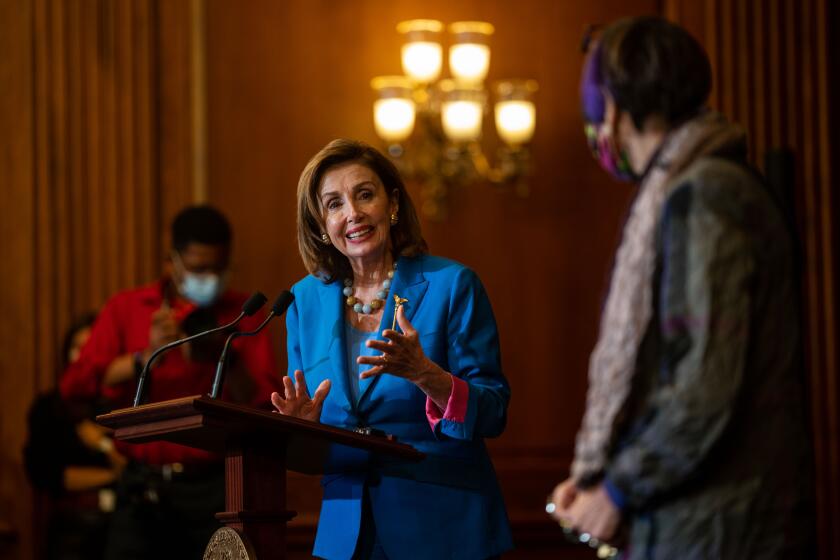 WASHINGTON, DC - SEPTEMBER 30: Speaker of the House Nancy Pelosi (D-CA) and House members in the Rayburn room on the House side of the U.S. Capitol during a bill enrollment ceremony for H.R. 5305, the Extending Government Funding and Delivering Emergency Assistance Act, on Thursday, Sept. 30, 2021 in Washington, DC. (Kent Nishimura / Los Angeles Times)