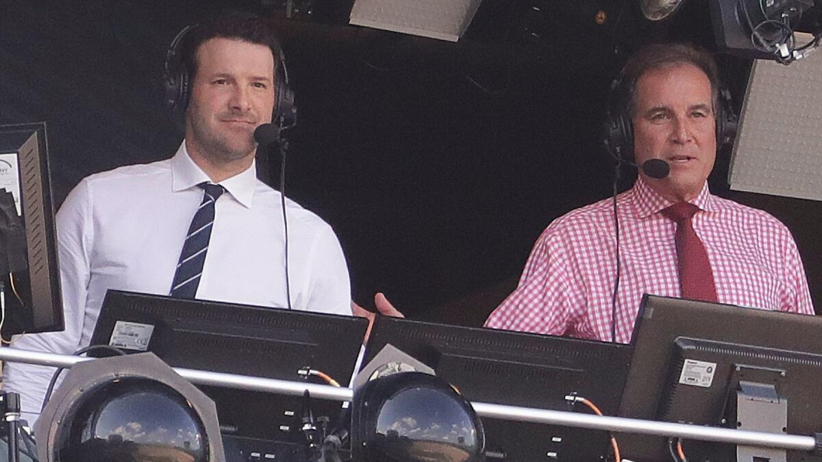 Tony Romo, left, and Jim Nantz sit in the broadcast booth before a game between the Green Bay Packers and Cincinnati Bengals on Sept. 24.