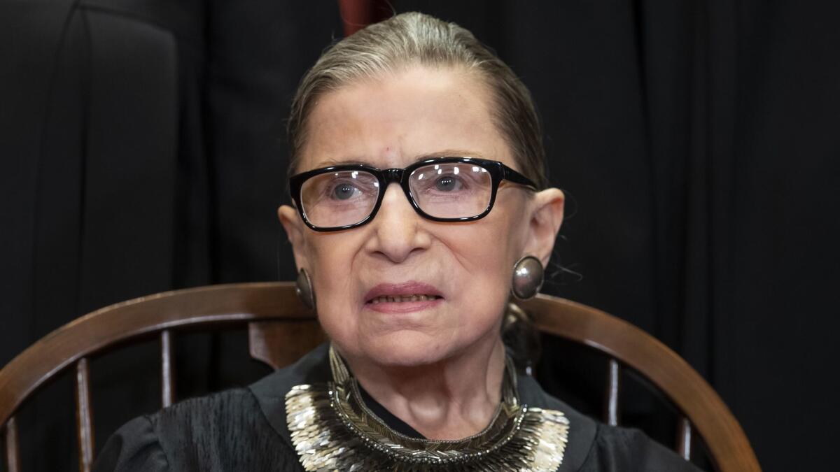 Justice Ruth Bader Ginsburg sits during a formal group portrait at the Supreme Court in Washington on Nov. 30, 2018.