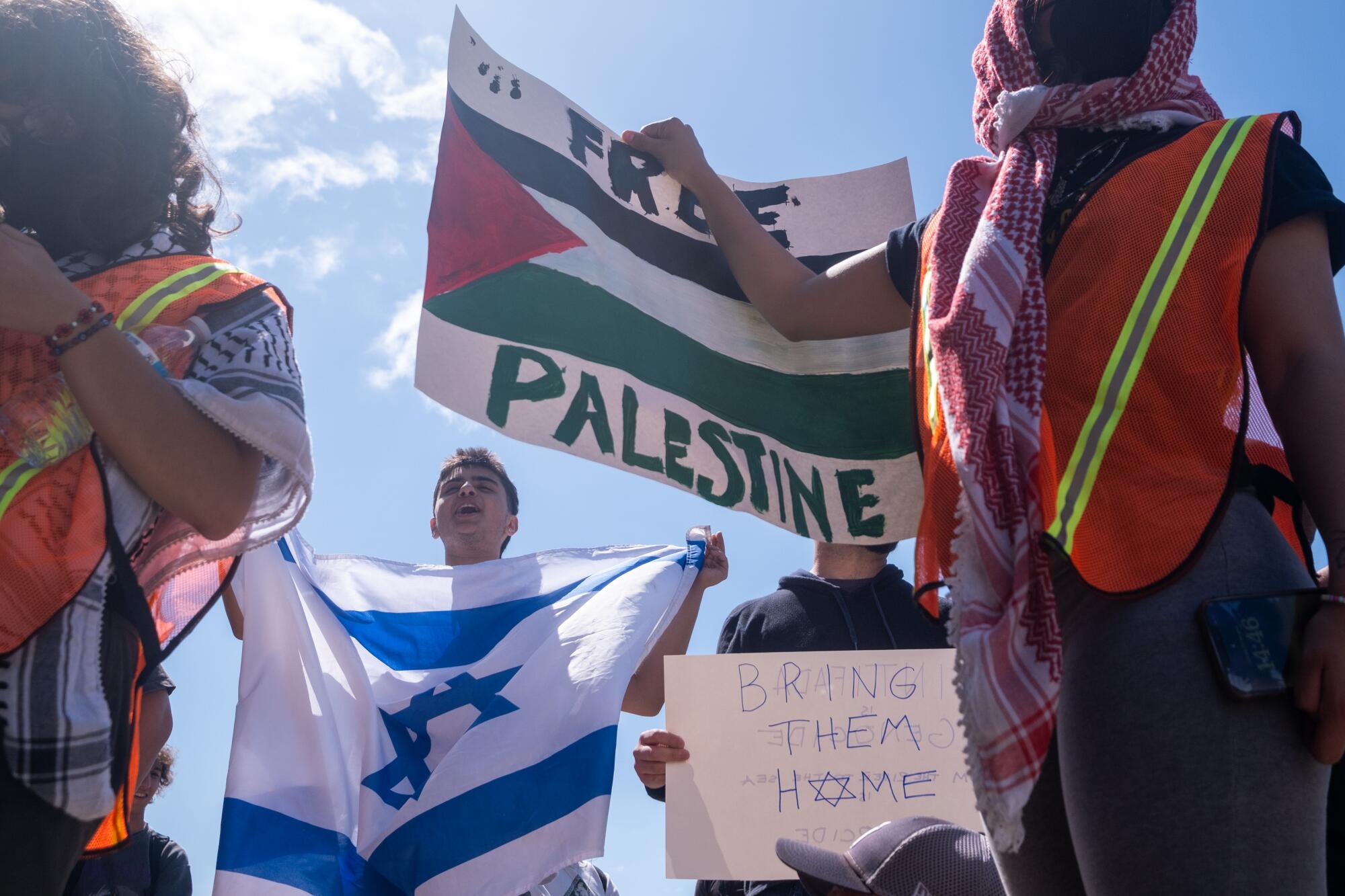 Pro-Israeli demonstrators gather near an encampment set up by pro-Palestine protesters on the campus of UCLA.