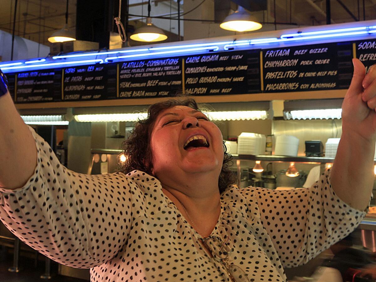Sara Clark, owner of Saritas Pupuseria in the Grand Central Market is famous for her handmade pupusas with a dozen different fillings. Fried plantains, yuca con chicharon, stews and other Salvadorean dishes are served at the counter under the light of a blue neon
