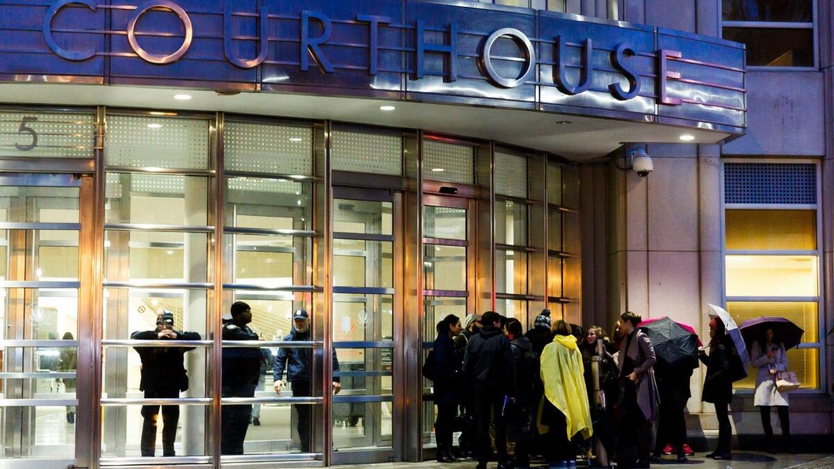 People wait in line to enter the federal courthouse in New York where the trial of Joaquin "El Chapo" Guzman is being heard.