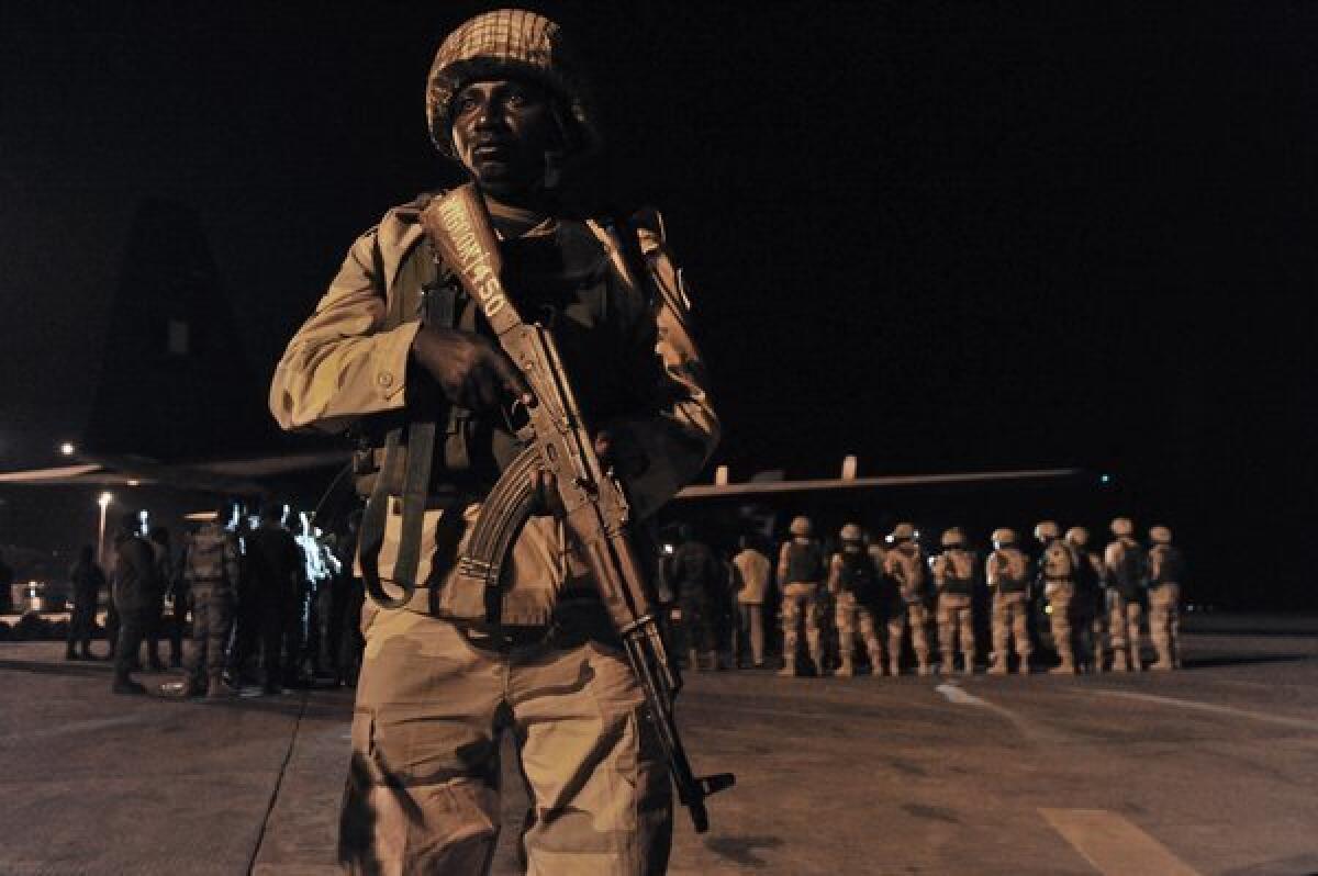 About 100 Nigerian troops, the first of a planned 3,300-member contingent from West African states, arrive in Mali's capital, Bamako, to join the fight against Al Qaeda-aligned Islamic militants who have seized the northern half of the country. French troops intervened a week ago with airstrikes and ground forces to avert the country's fall to the extremists.
