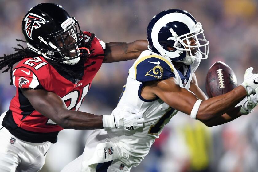 LOS ANGELES, CALIFORNIA JANUARY 6, 2018-Rams receiver Robert Woods makes a catch in front of Falcons cornerback Desmond Trufant to set up a field goal late inthe 2nd quarter in the 1st round of the NFL Playoffs at the Coliseum Saturday. (Wally Skalij/Los Angeles Times)