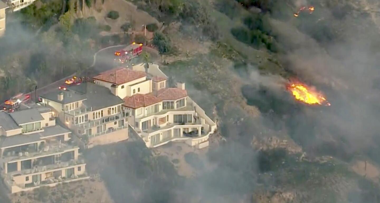 An aerial view of the brush fire that is threatening homes near Irvine Cove in Laguna Beach.