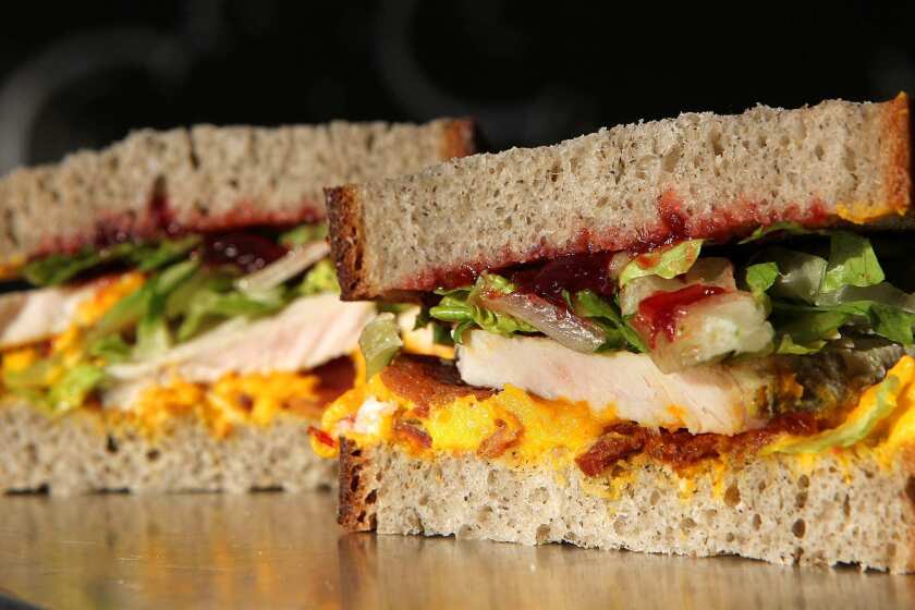 A turkey sandwich made with buckwheat bread, kabosha squash whipped with creme fraiche, applewood smoked bacon, hot carved turkey, romaine and cranberry chutney, as prepared at Mendocino Farms in West Hollywood. Recipe
