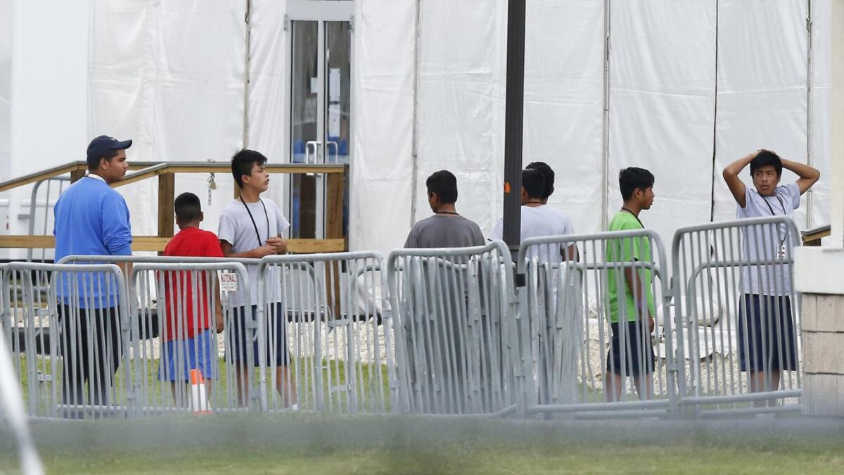 Migrant children wait in a federal detention camp. A federal judge Thursday gave the government six months to reunite the thousands of migrant families it separated.