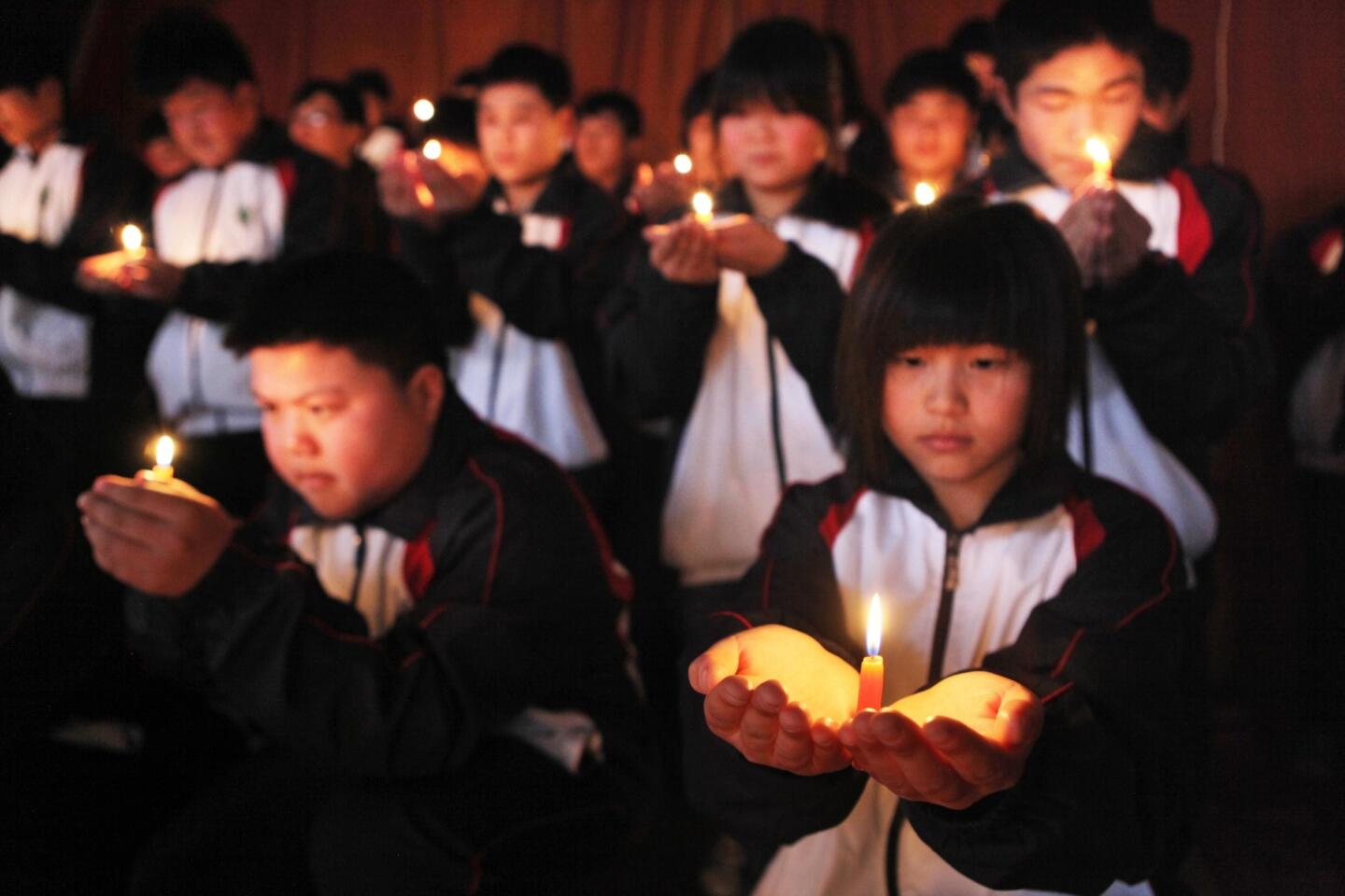 Students hold a vigil for passengers of the missing Malaysia Airline flight MH370 in Lianyungang, China, on March 25.