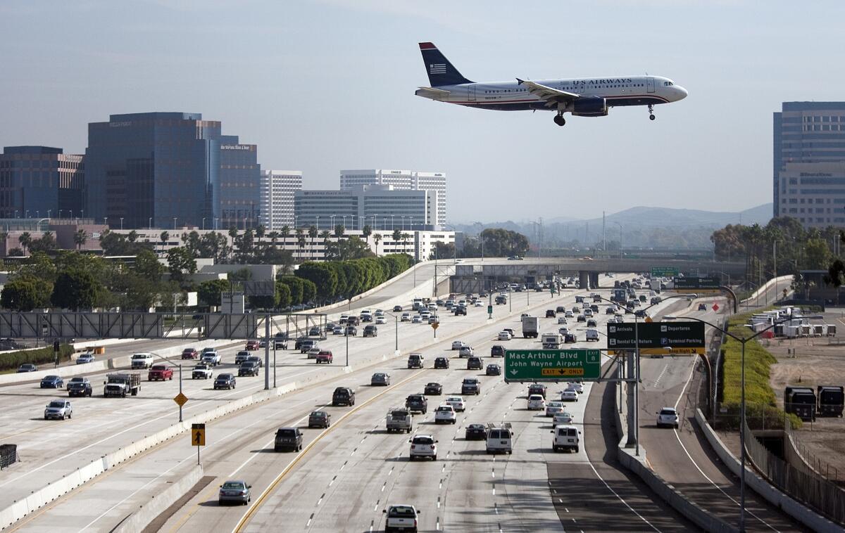 A U.S. Airways airplane flies over the 405 freeway as it approaches John Wayne Airport in Orange County.