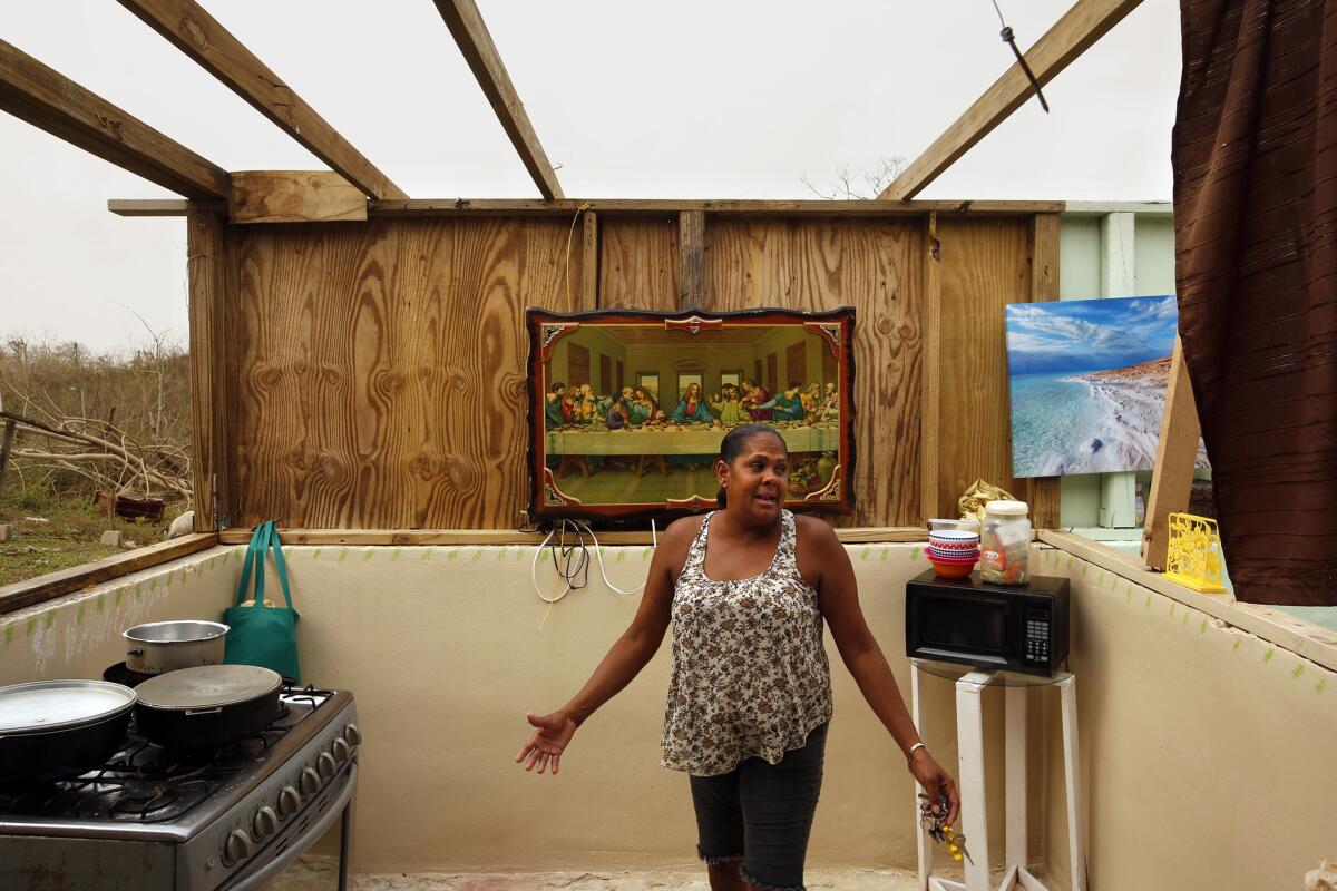 Omayra Cruz, 44, a single mother, returned from a food distribution site with a box she would share with her 4-year-old son. Nene. The two are living without a roof, sleeping under the stars. Their water tank has a few inches left.