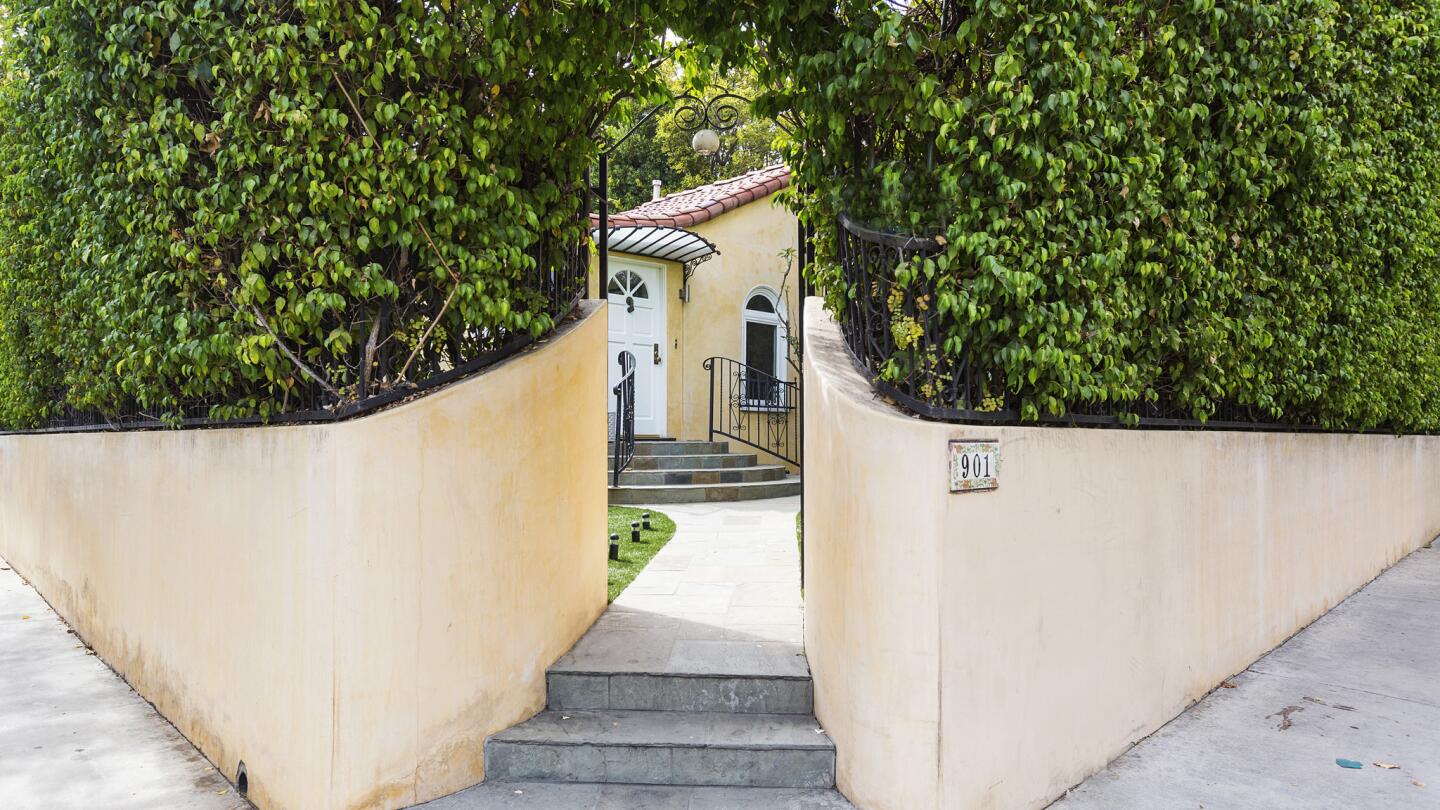 Arched doorways, hardwood flooring and a communal courtyard with a fireplace are among the features at Dunaway's WeHo residence.