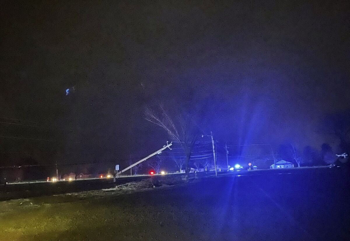This photo provided by Madison County Sheriff's Office, authorities closed down a road after power lines came down and homes suffered damage early Sunday, Jan. 2, 2022 in Hazel Green, Ala. The storms followed a system earlier Saturday which brought a possible tornado and flooding to parts of Kentucky. (Madison County Sheriff's Office via AP)