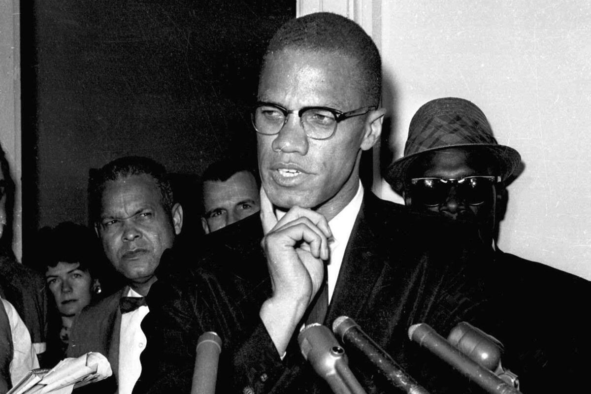FILE - Malcolm X speaks to reporters in Washington on May 16, 1963. Fifteen years after being rejected as too controversial, Malcolm X has been inducted as the newest member of the Nebraska Hall of Fame. The organization's commission selected the civil rights icon on Monday, Sept. 12, 2022, on a 4-3 vote. (AP Photo, File)
