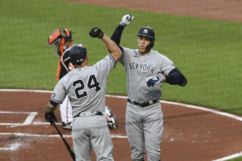 New York Yankees' Aaron Judge, right, celebrates with Gary Sanchez after hitting a first-inning home run against Baltimore Orioles starting pitcher Dean Kremer during a baseball game on Friday, May 14, 2021, in Baltimore. (AP Photo/Terrance Williams)