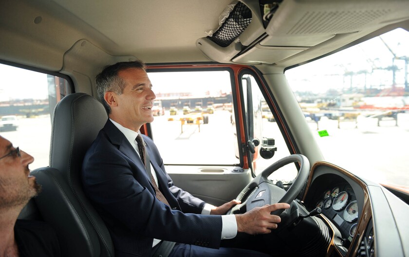 Mayor Eric Garcetti test drives an electric truck. The port wants to use cleaner vehicles and equipment to improve air quality.