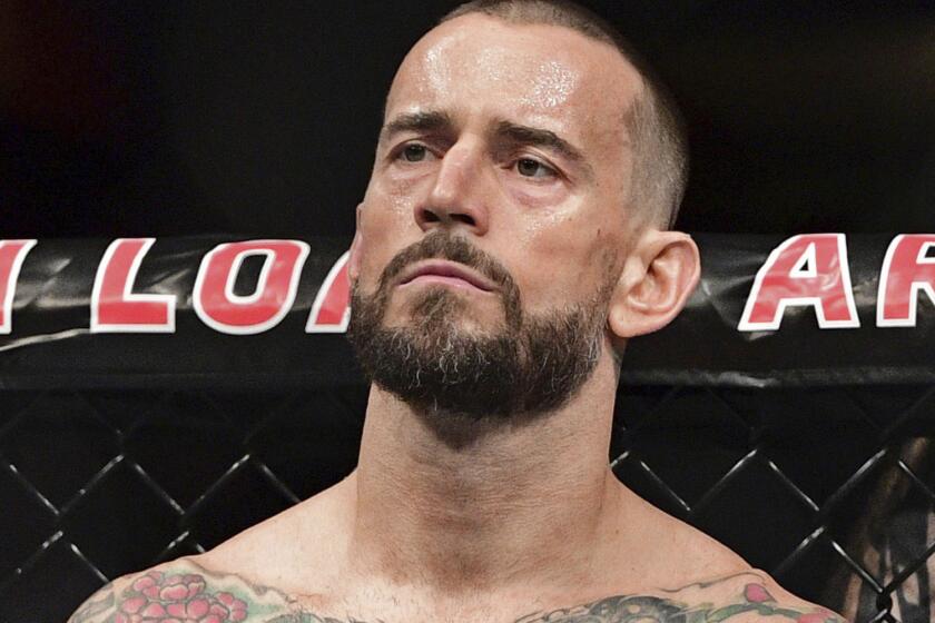 FILE - In this Sept. 10, 2016, file photo, CM Punk stands in his corner before a welterweight bout at UFC 203 in Cleveland. Punk went 0-2 in UFC and has given himself until the new year to decide if he wants to keep fighting. Punk hopes to stick in the sport as a mixed martial arts announcer. (AP Photo/David Dermer, File)