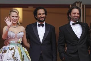 Maria Bakalova, from left, director Ali Abbasi, and Sebastian Stan pose for photographers upon arrival at the premiere of the film 'The Apprentice' at the 77th international film festival, Cannes, southern France, Monday, May 20, 2024. (Photo by Scott A Garfitt/Invision/AP)