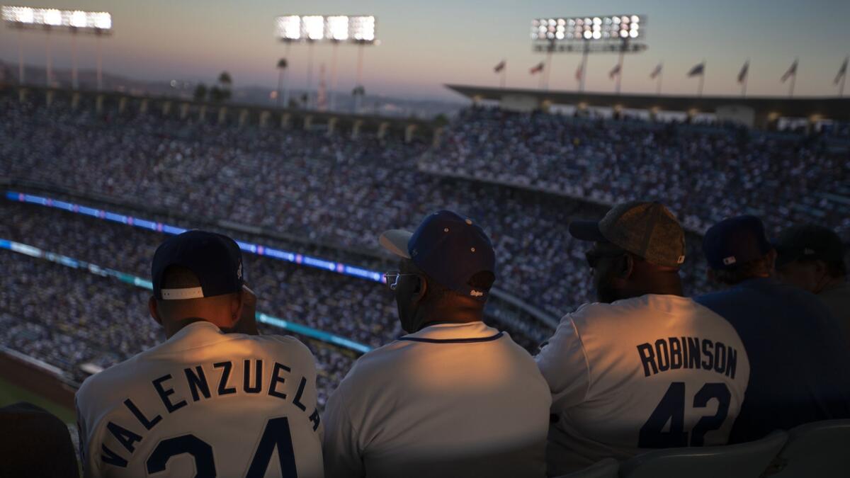 Dodgers fans watch Game 3 of the World Series between the Dodgers and Boston Red Sox at Dodger Stadium on Oct. 26.