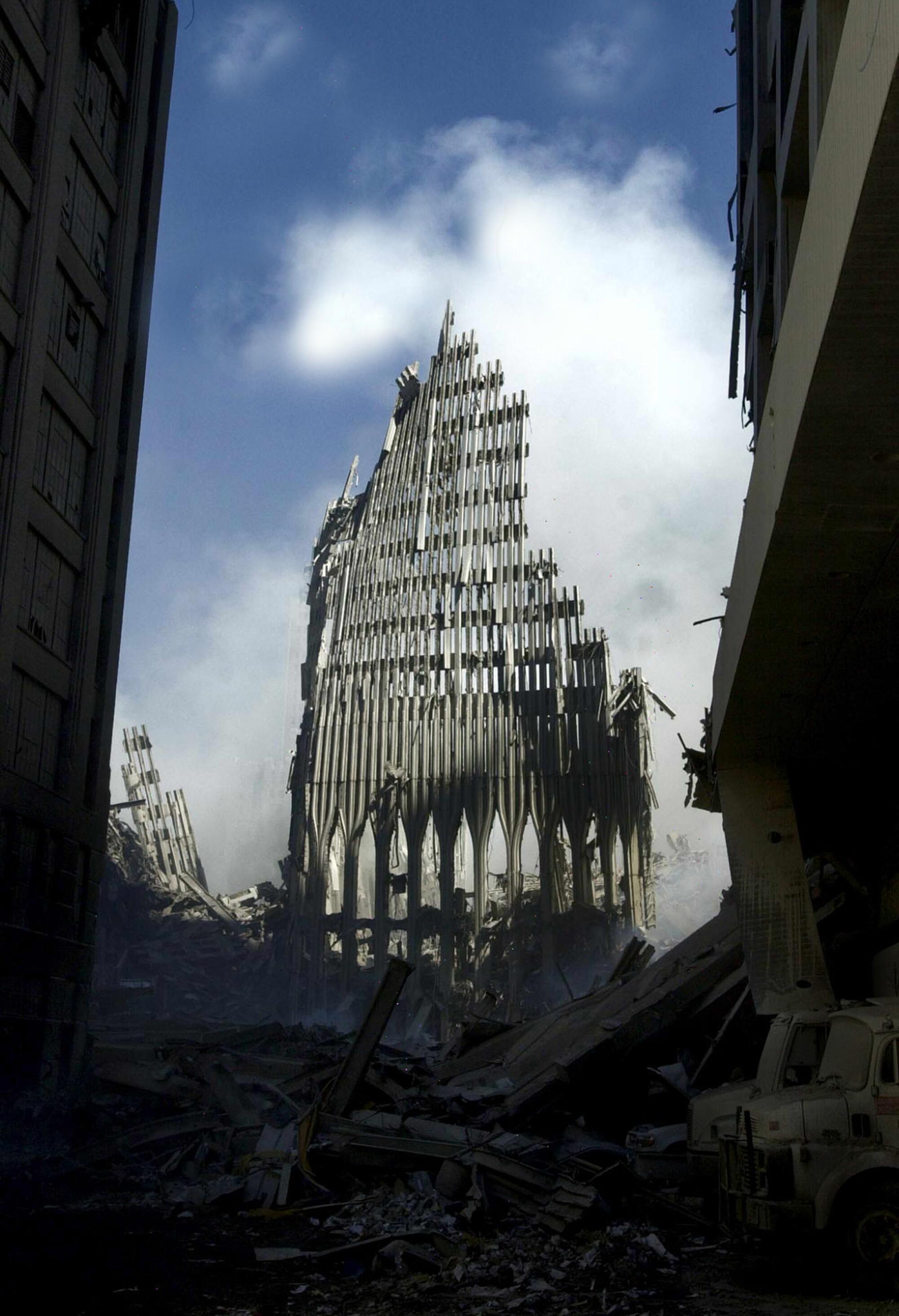 The remains of a building stands amid the rubble