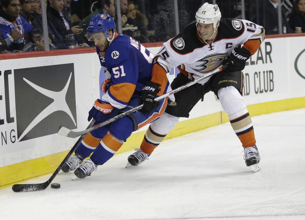 Ducks forward Ryan Getzlaf and New York Islanders tk Frans Nielsen fight for control of the puck during the second period of a game on Dec. 21.
