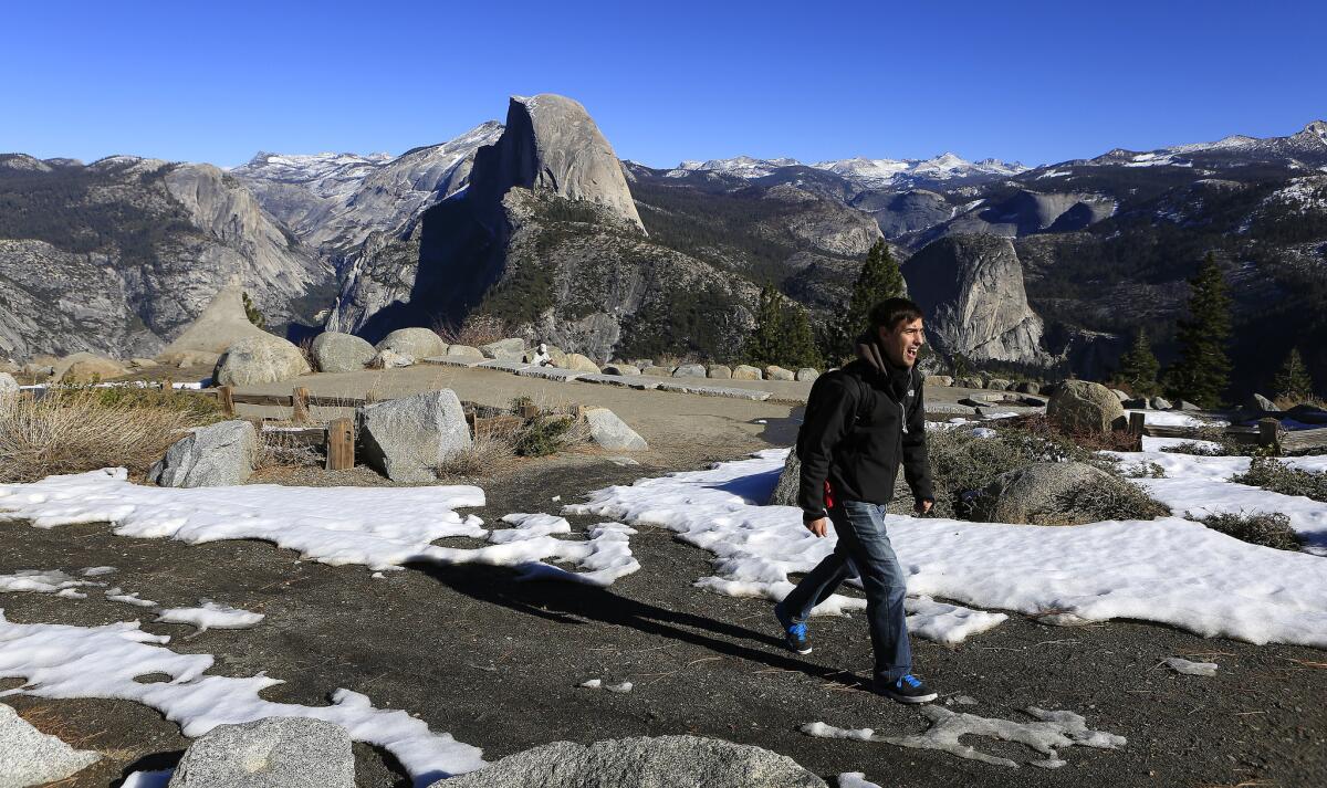 Darrell Carlis of Fresno hikes past patchy snow at Glacier Point in Yosemite National Park on Jan. 23. The arrival of a potentially powerful El Ni?o this coming winter could rejuvenate the thin Sierra snowpack.