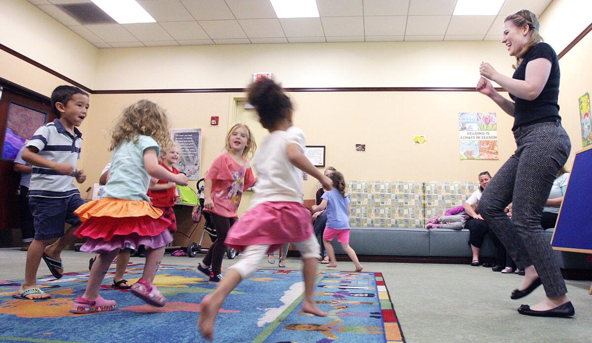 Under the leadership of children's librarian Jenny Darwent, young children dance in the Rhythm and Reading program at the Buena Vista Branch Library in Burbank on Thursday, March 24, 2016. The activity started last year and returns to the library every two weeks.