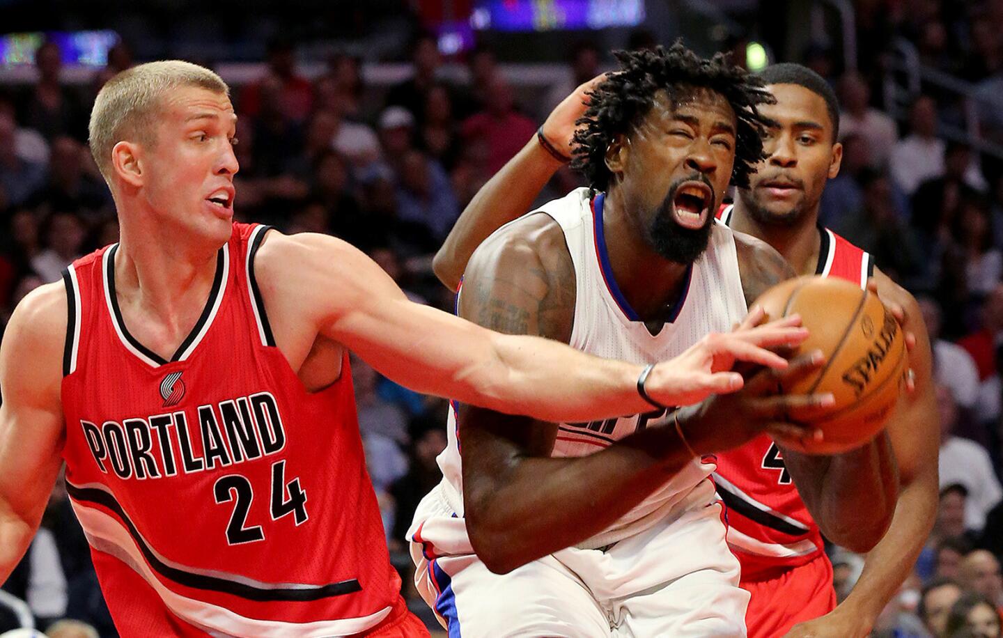 Clippers center DeAndre Jordan is fouled by Trail Blazers big man Mason Plumlee in the second quarter on Wednesday.