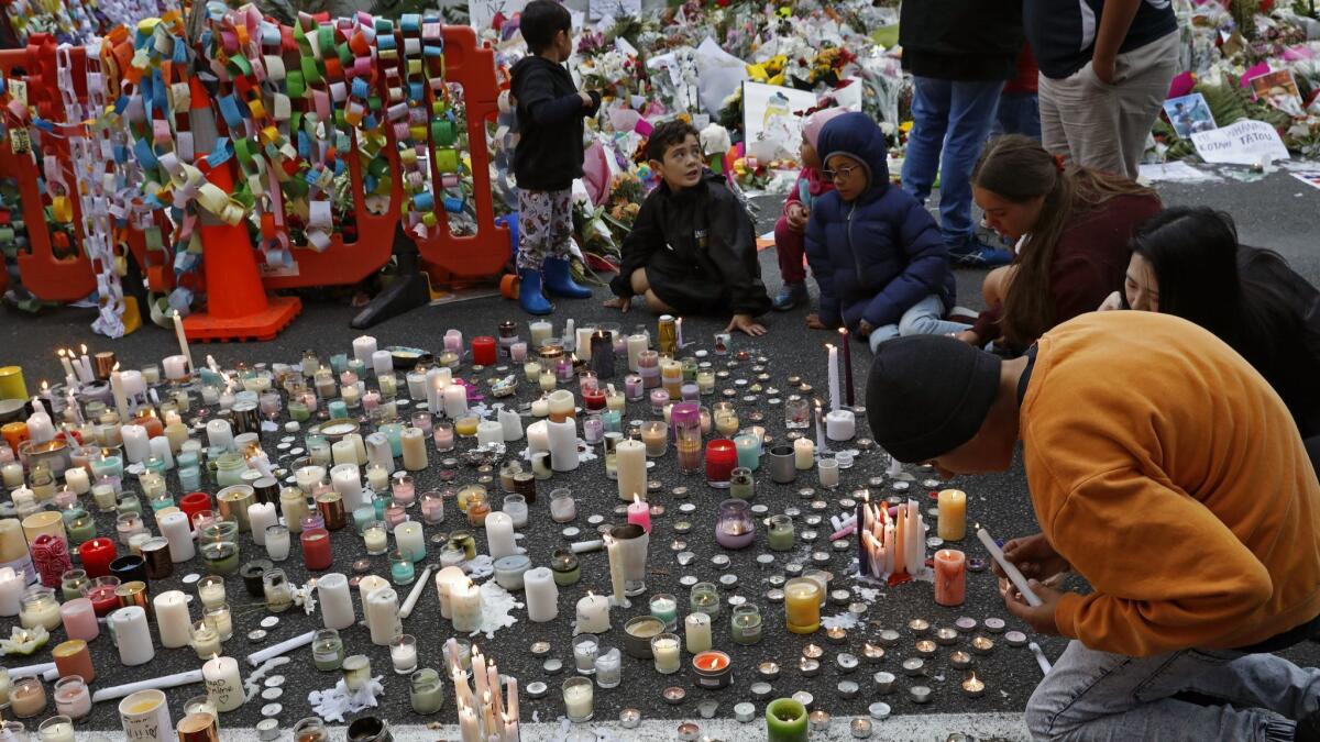 Students light candles for the victims in Christchurch.