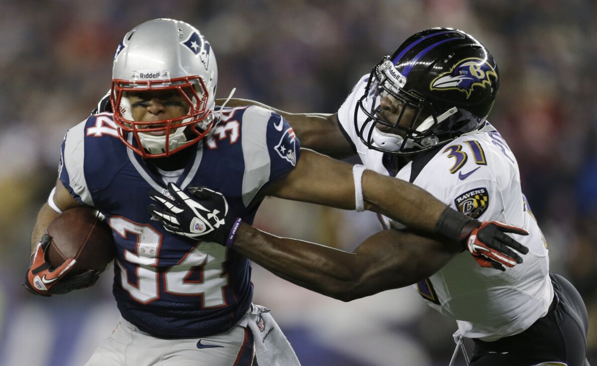 New England Patriots running back Shane Vereen, left, is tackled by Baltimore Ravens safety Bernard Pollard in the AFC championship game.
