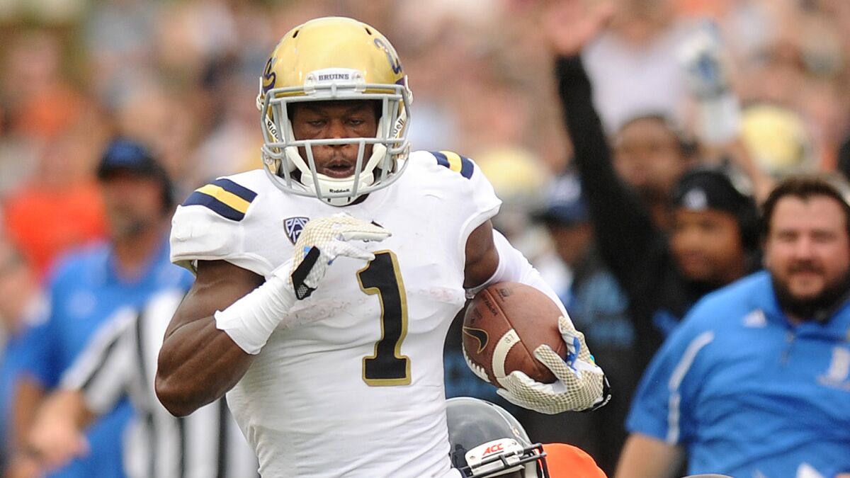 UCLA's Ishmael Adams scores on a punt return during the first quarter of Saturday's win over Virginia.