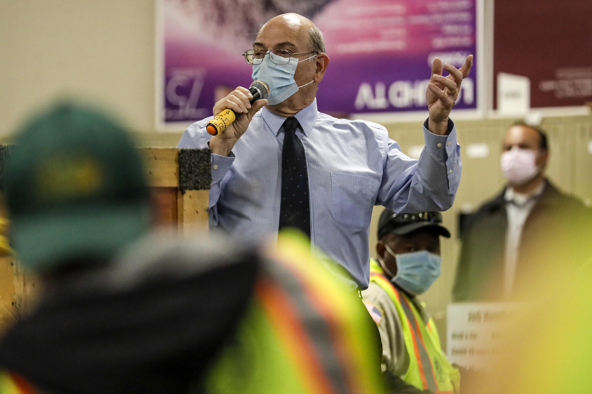 Marc Monforte, director of material management and purchasing, speaks to truck drivers assembled early morning at LAUSD Procurement Services Center in Pico Rivera