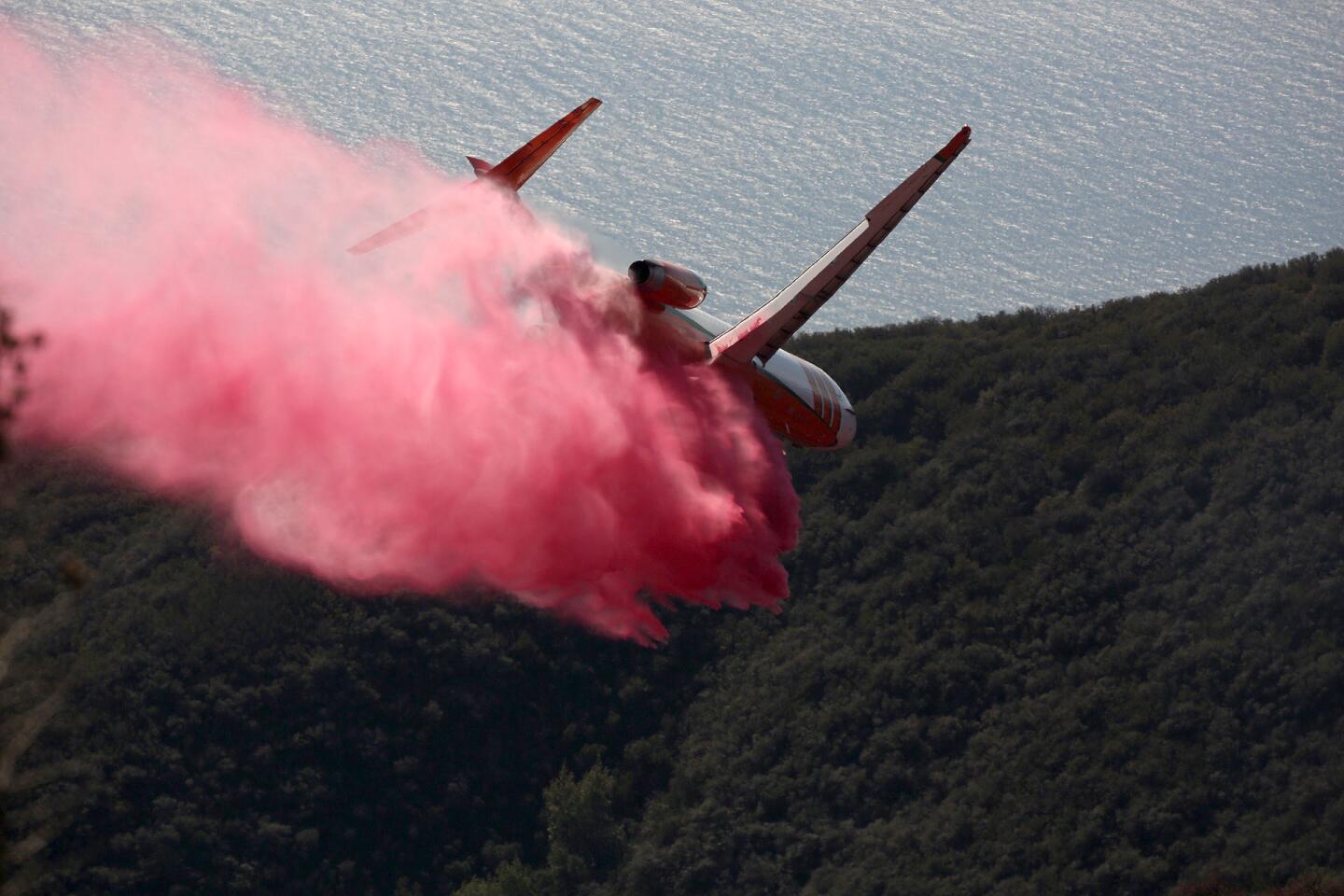 An aerial tanker drops fire retardant on a brush fire that broke out in the area of Montecito Peak near Santa Barbara on Thursday.