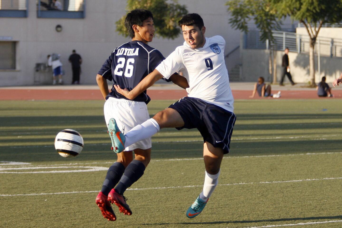 Loyola's Matthew Koh, left, and CV's Eric Keshishian fight for the ball during a game at Crescenta Valley High School on Tuesday, December 11, 2012.