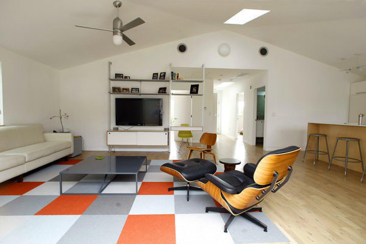 Robert Sweet of the firm Ras-a transformed a rundown 1952 house by opening up the interior, moving rooms and raising the ceiling so the living area felt larger.