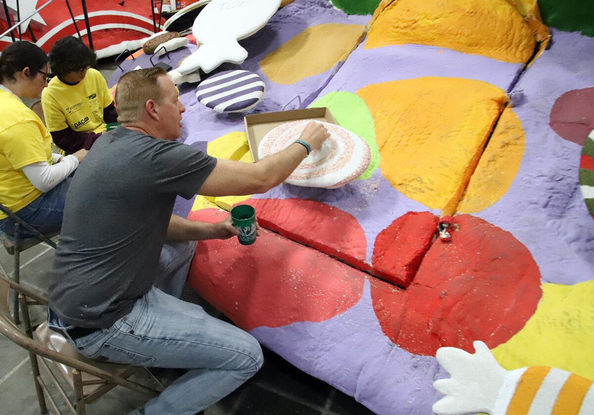 Chad Gloetzner of Mission Viejo volunteers his time to work on Newport Beach's float.