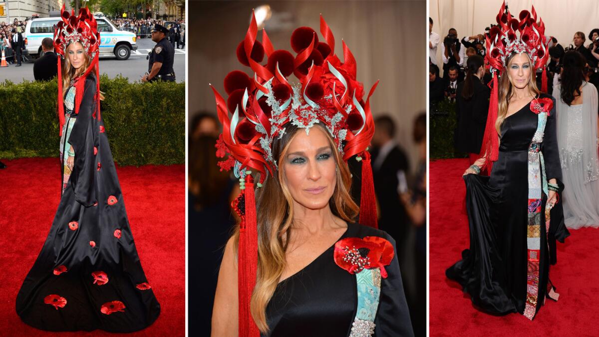 Sarah Jessica Parker wears a black satin one-shouldered gown featuring embroidery and embellished with flowers, which was designed in collaboration with H&M and a Philip Treacy headpiece.