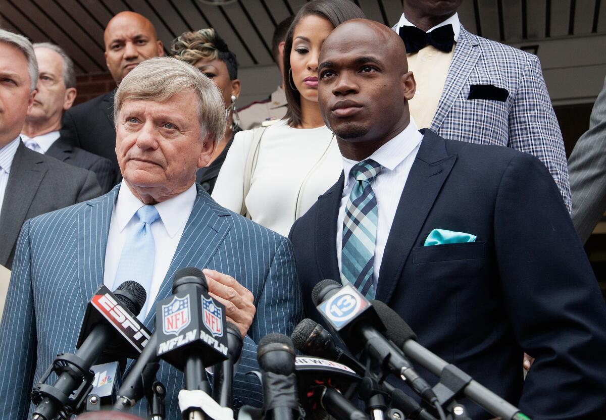 Defense attorney Rusty Hardin (left) and running back Adrian Peterson of the of the Minnesota Vikings address the media Tuesday.